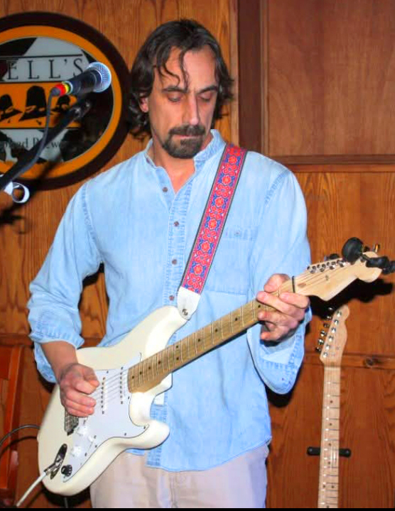 John D'Amato playing electric guitar